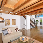 A living room with a couch and stairs