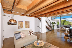 A living room with a couch and stairs