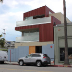 A car parked in front of a building on the side of a street.