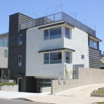 A modern style house with a balcony and a garage.