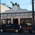 A black car parked in front of a store.
