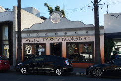 A black car parked in front of a store.