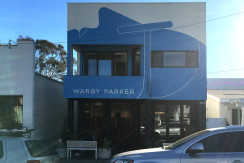 A building with a car parked in front of it.