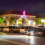 A group of cars parked in front of a building.