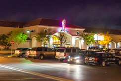 A group of cars parked in front of a building.