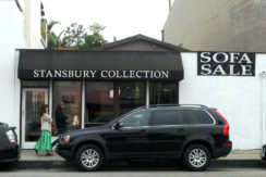 A black suv parked in front of a store.