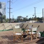 A deck with chairs and tables on it