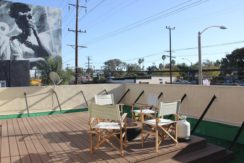 A deck with chairs and tables on it