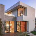 A modern house with a large glass sliding door.