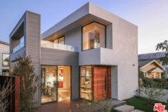 A modern house with a large glass sliding door.