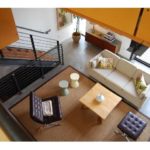 A living room with stairs and furniture in it