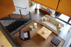 A living room with stairs and furniture in it