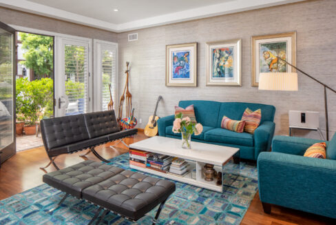 A living room with blue couches and chairs